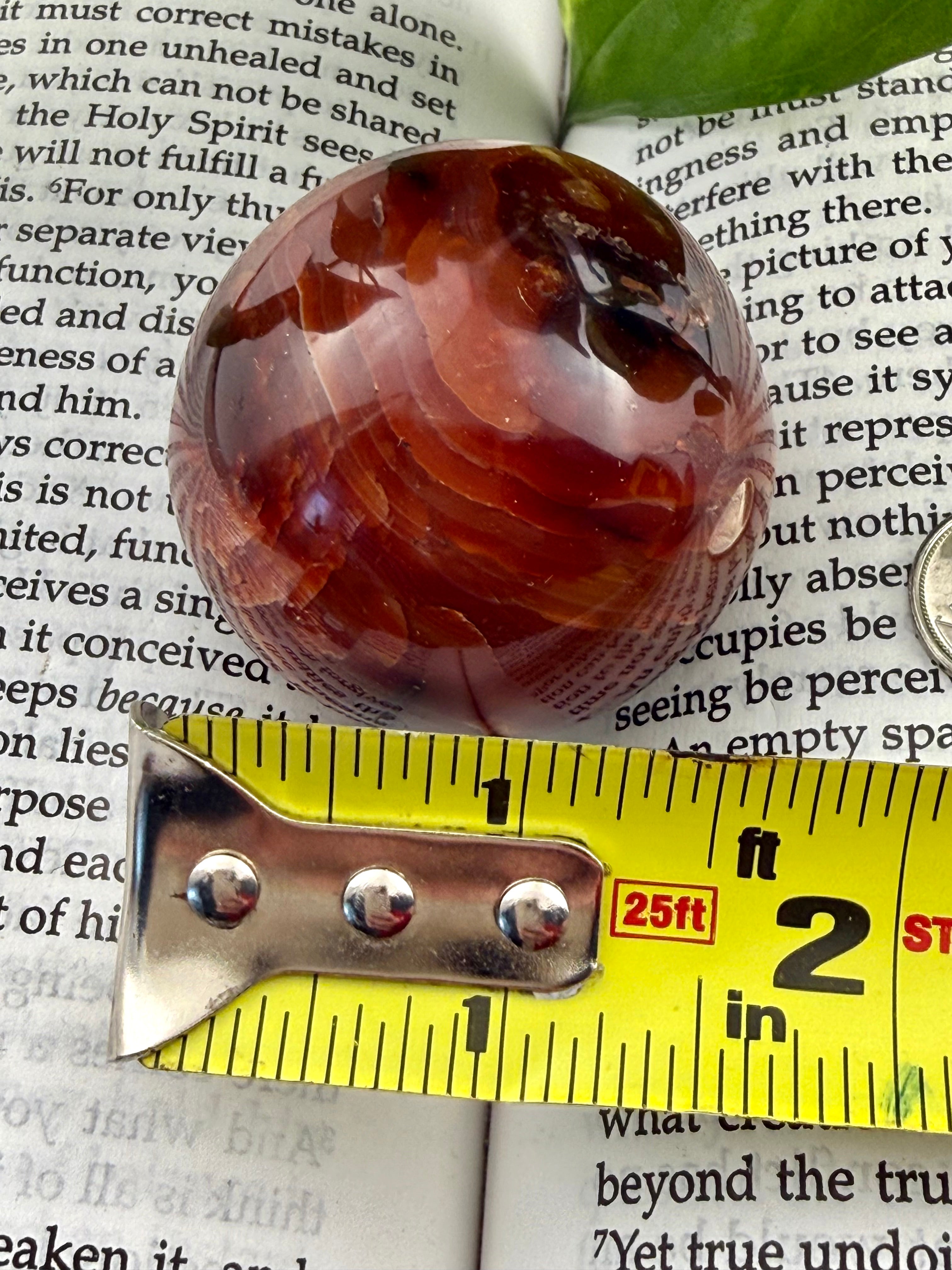 carnelian sphere with measuring tape showing approx 1.5"