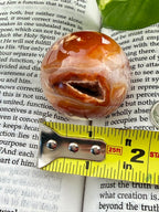 Carnelian Sphere with measuring tape showing it to be about 1.5"