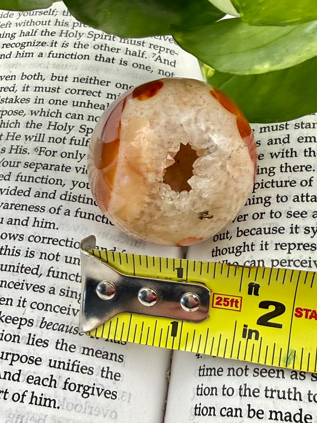 Carnelian sphere showing druzy and measuring tape to show the size - approx 1.5"
