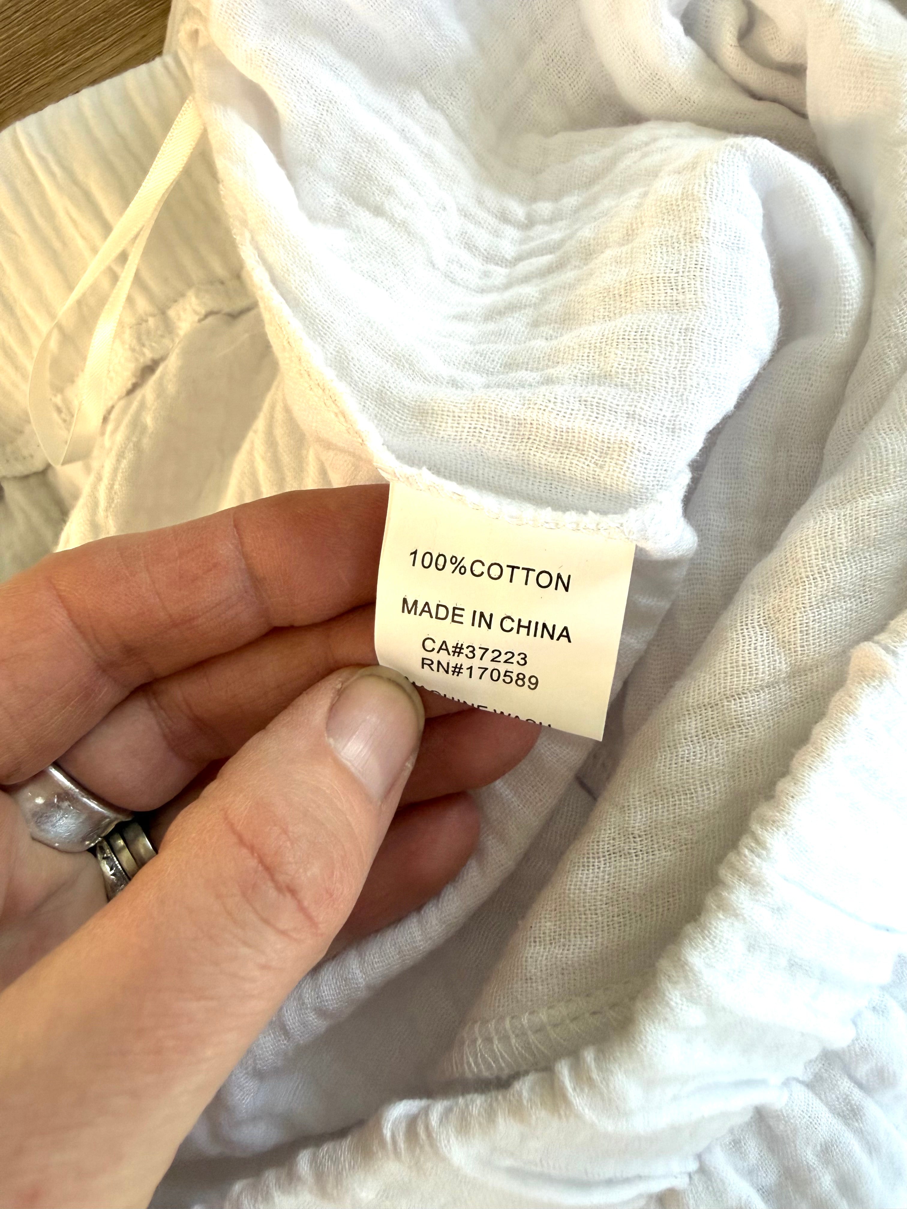 100% cotton inside tag on NWT Creation 100% Cotton Gauze Wide-Leg Pants — White | Button Hem Detail | Size XL at Blue Sparrow Shop