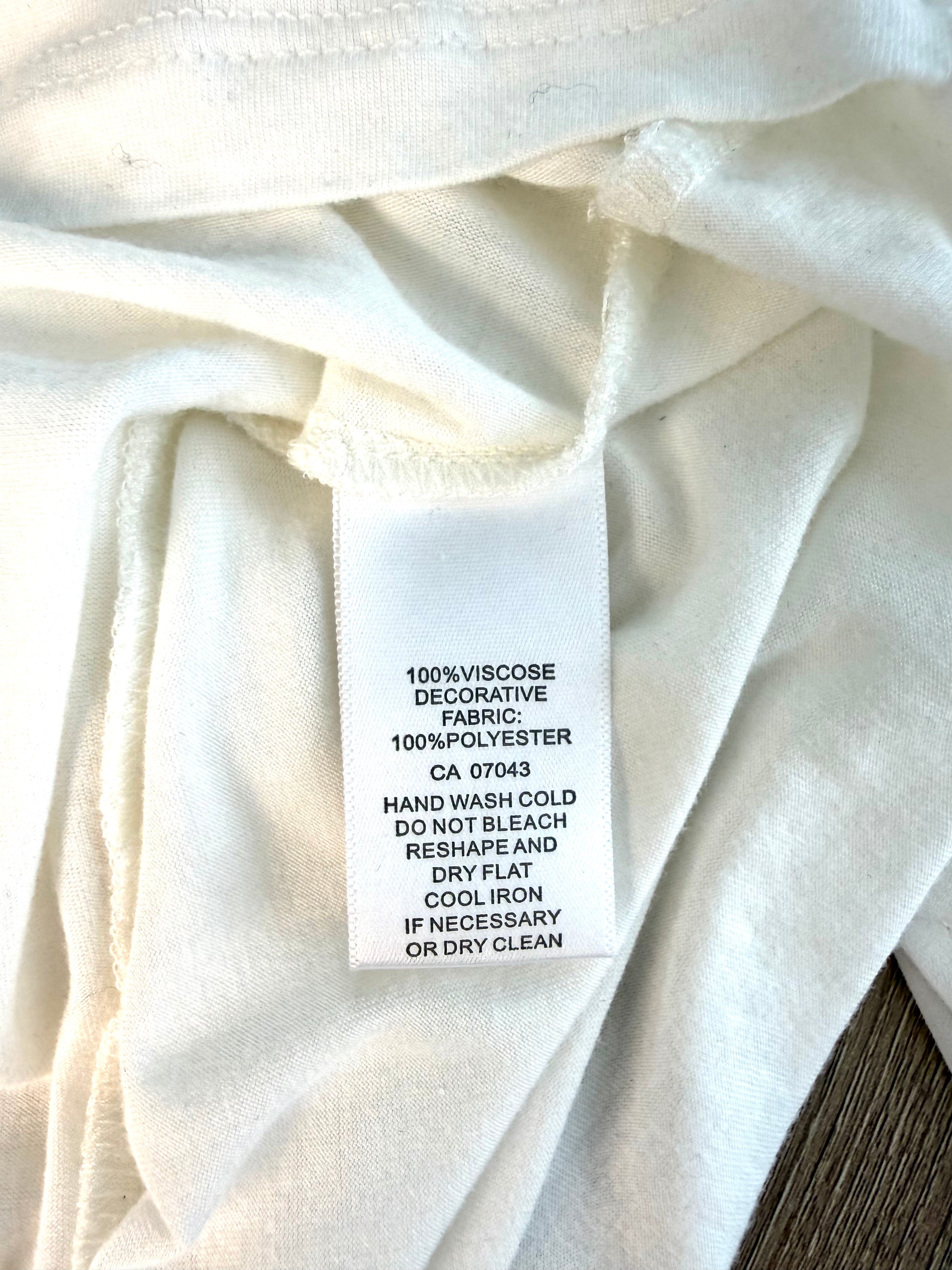 100 percent viscose outer tunic white sleeveless layering blouse care tag detail