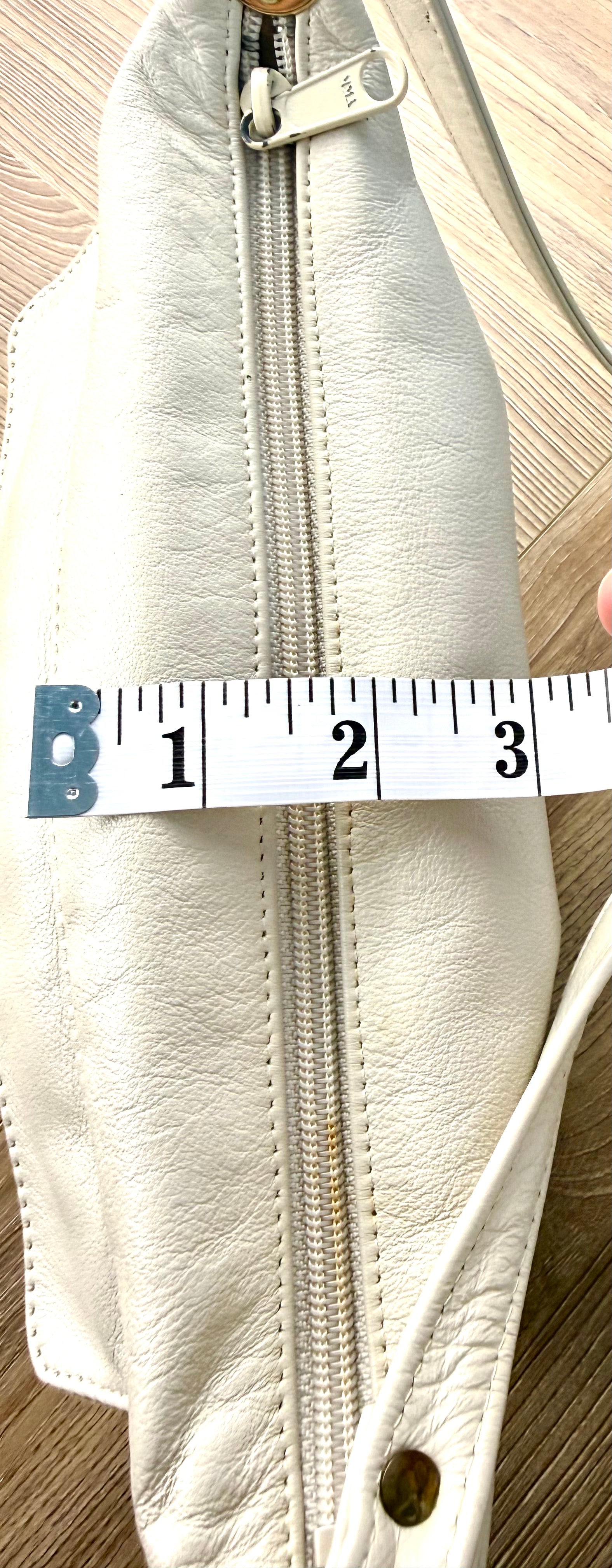 80's style retro leather bag - made in Canada measuring about 3" when full 