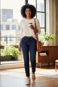 99% Cotton NYDJ Dark Wash Petite Straight Leg Jeans | Size 10P at Blue Sparrow Shop on woman with take out coffee in office