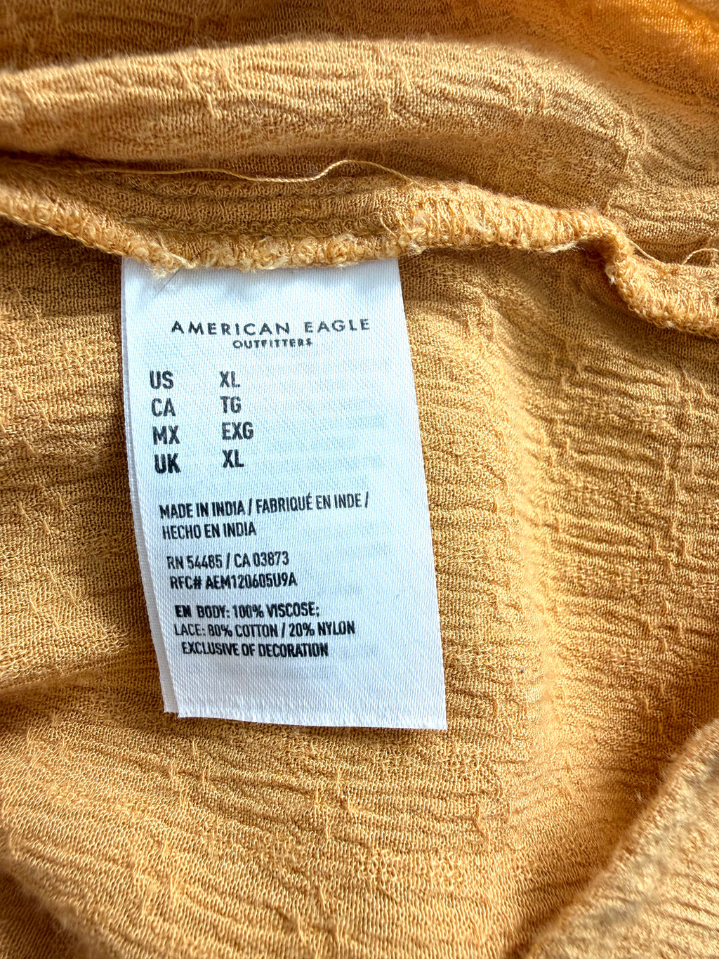 American Eagle care tag showing 100% viscose body and lace blend details, made in India.