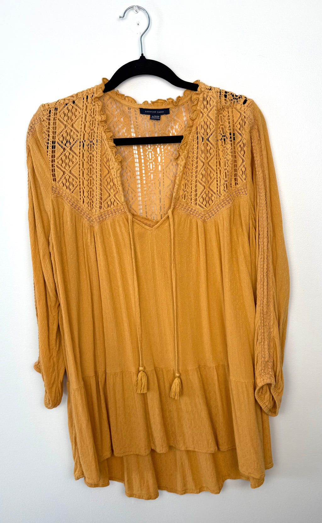 American Eagle mustard boho tunic with lace yoke detail, long sleeves, tie neckline with tassels, and tiered hem, size XL.
