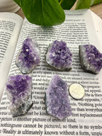 5 small amethyst clusters on book 