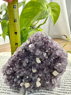 Amethyst Cluster with measuring tape showing it to be approx 4 inches tall and triangular shaped
