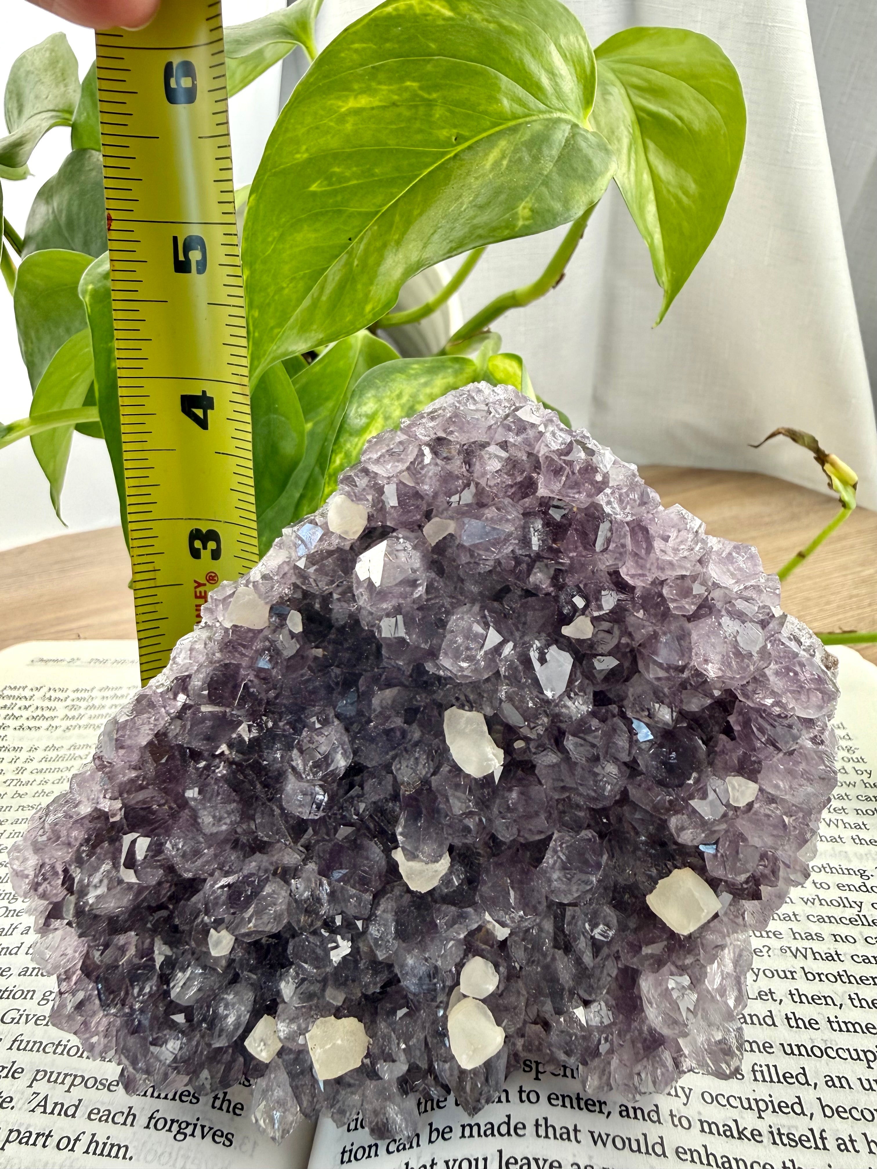 Amethyst Cluster with measuring tape showing it to be approx 4 inches tall and triangular shaped