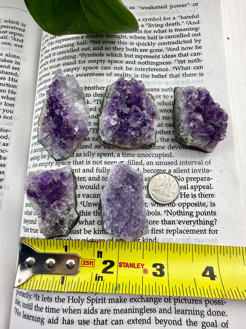 amethyst clusters with measuring tape showing them to be about 1 inch wide
