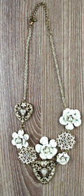 Antique gold-tone filigree heart and ivory enamel rose cluster statement necklace laid flat with measuring tape, full length view, rhinestone accents visible — Blue Sparrow pre-loved jewellery