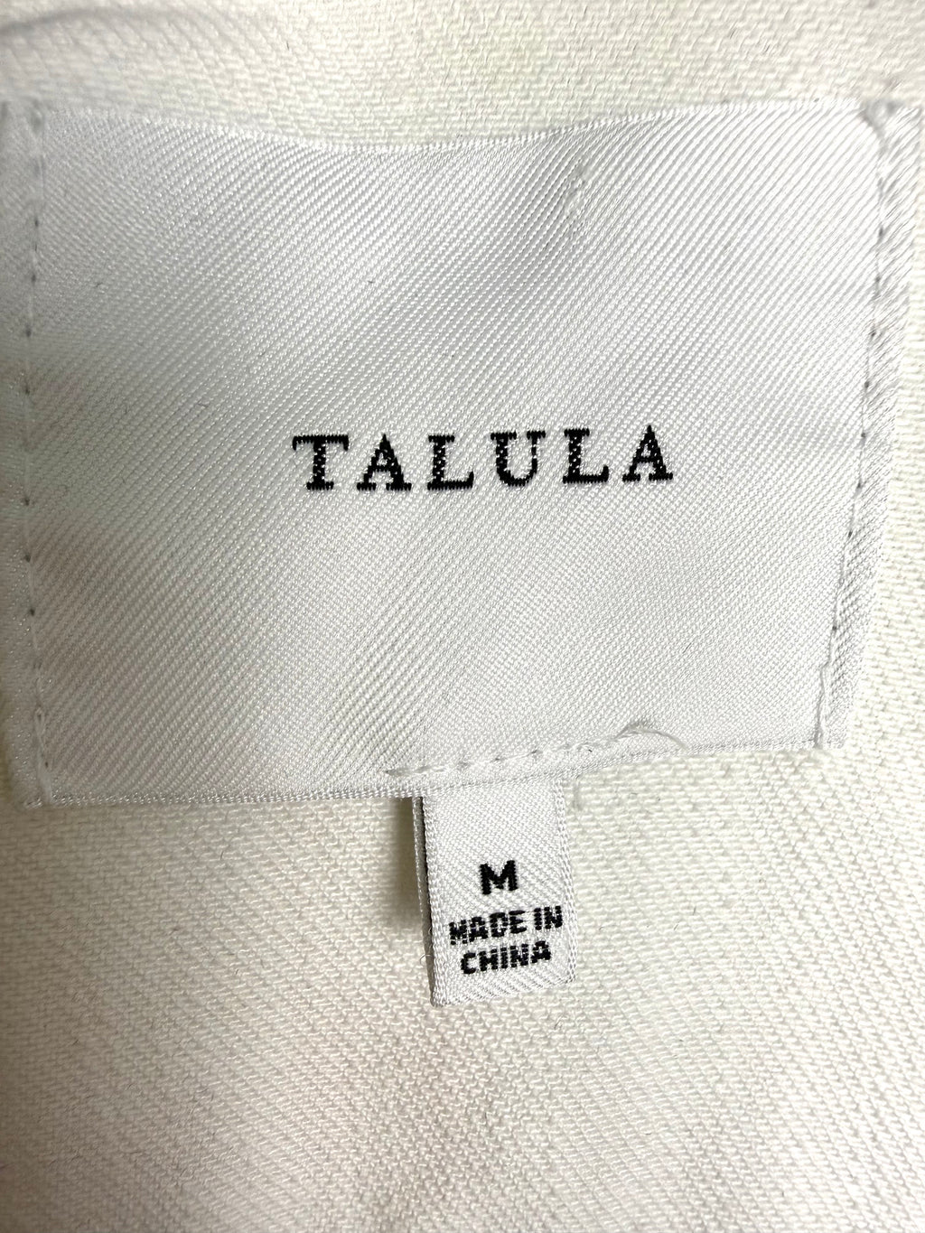 Aritzia Talula Distressed cropped denim jacket inside label 