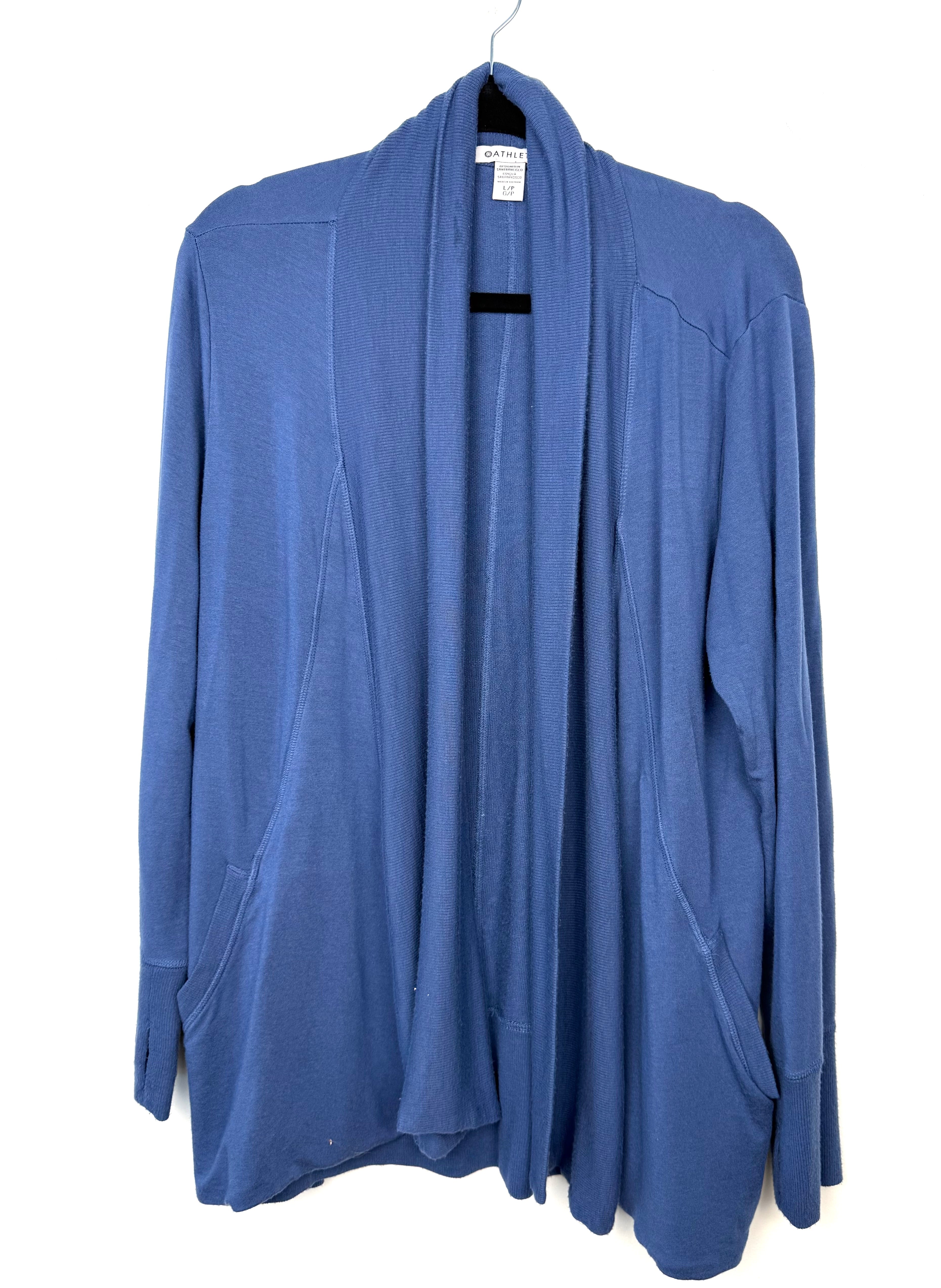 Athleta Pranayama wrap cardigan in blue, open front drape style with ribbed shawl collar and front pockets, women’s athleisure layering piece on  hanger