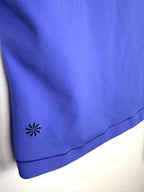 Athleta logo detail on blue performance top hem