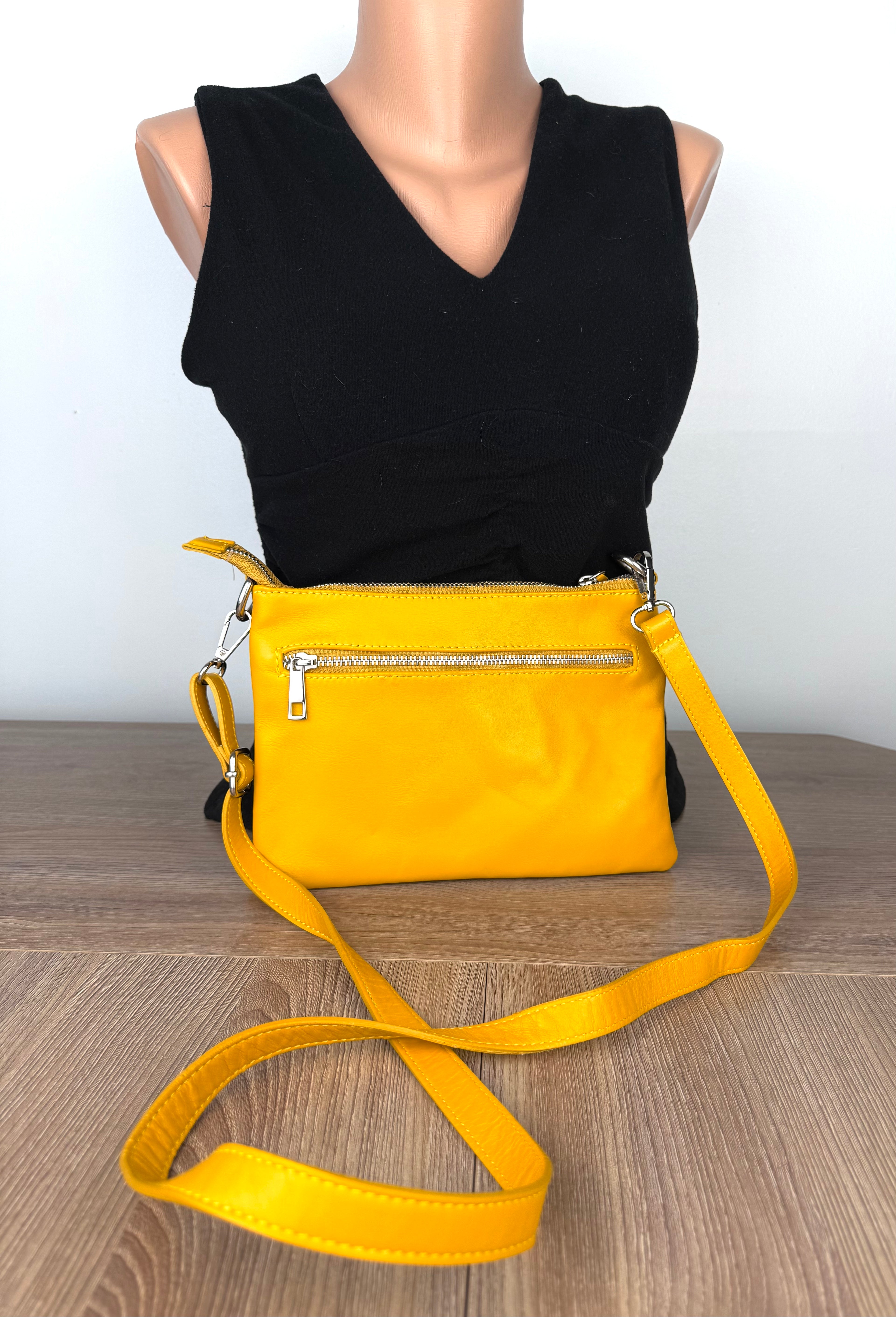 Back view of Enzo Bertini yellow leather crossbody purse with exterior zip pocket