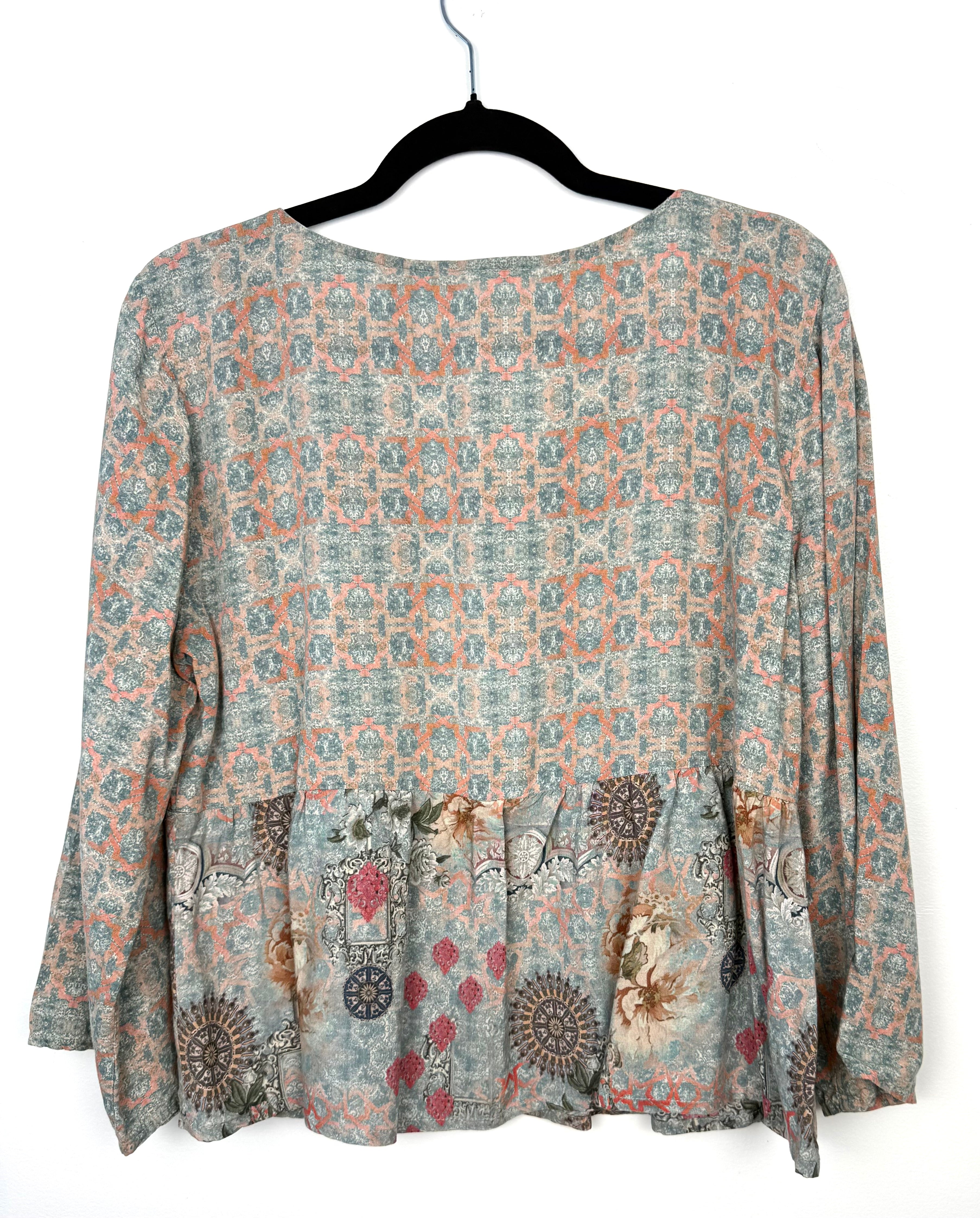 Back view of Mahla mixed print blouse in soft sage and coral geometric pattern with flowy peplum hem and relaxed silhouette in breathable modal fabric.
