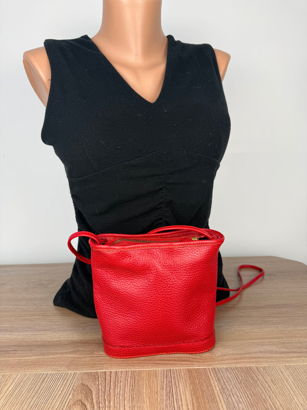 Red pebbled leather crossbody bag by Laurentian Chief back view