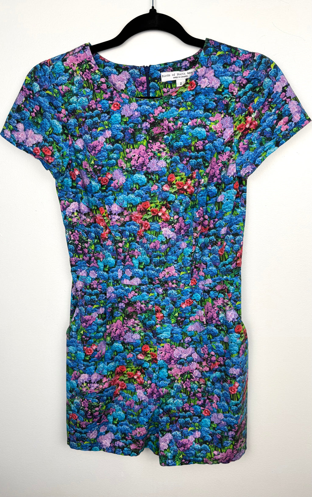 front of Birds of North America floral romper with impressionist hydrangea print on hanger