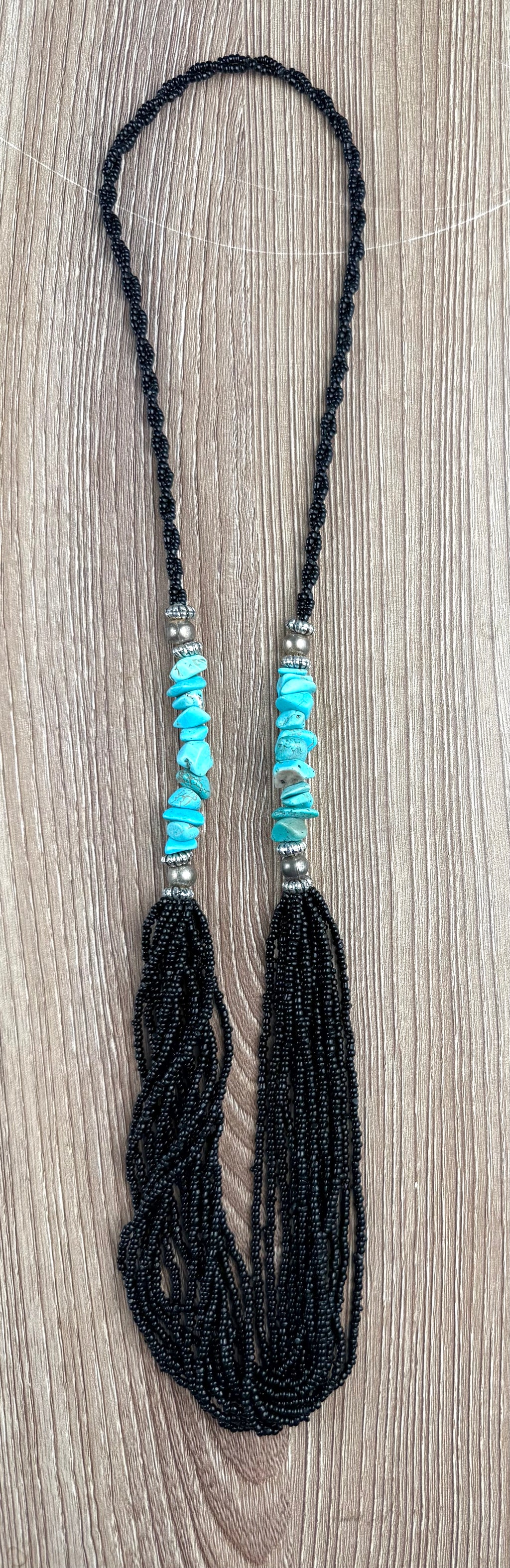 Black Seed Bead & Turquoise Stone Tassel Necklace on table