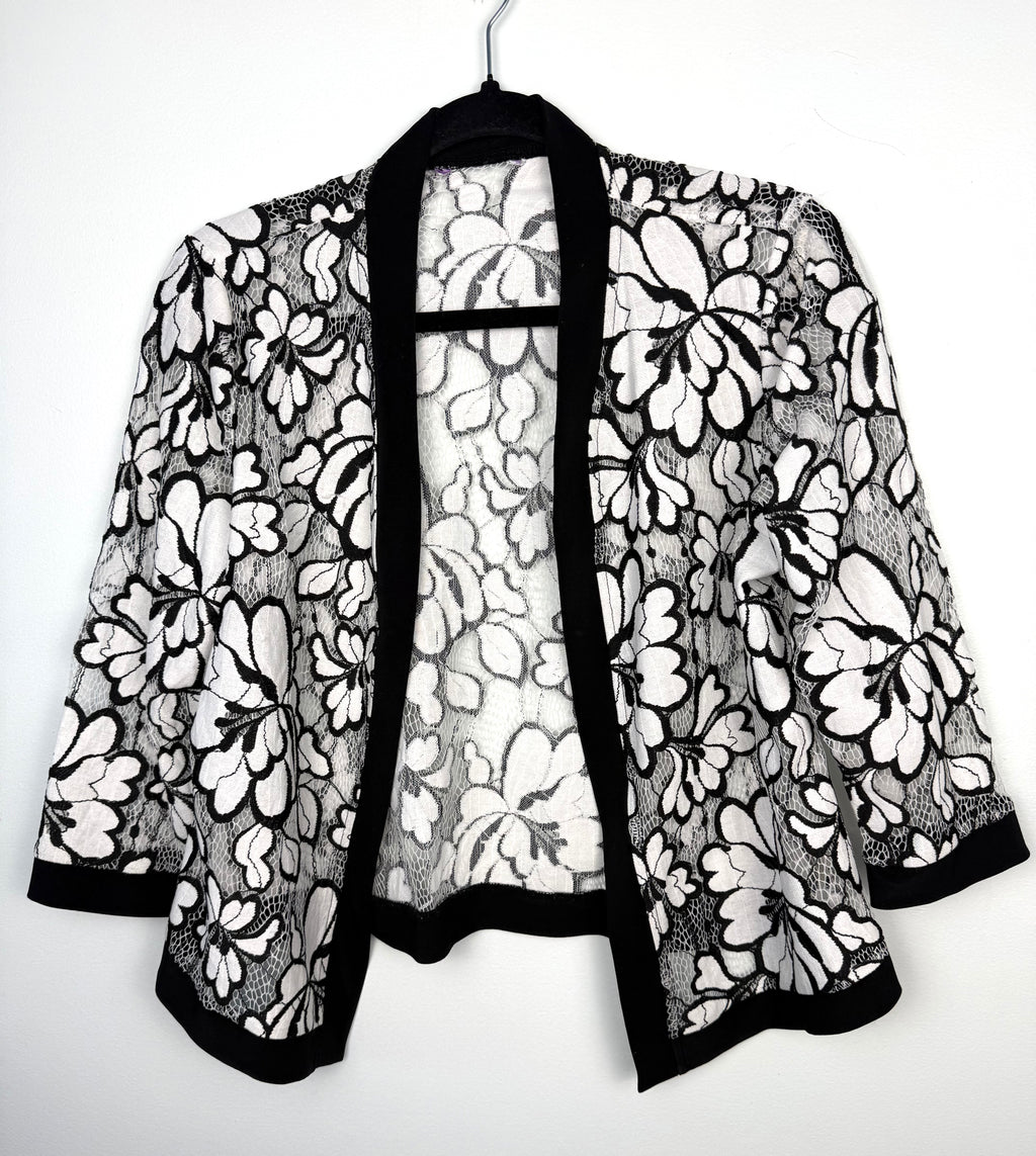 Black and white floral lace open front cardigan, lightweight sheer lace jacket with cropped silhouette and 3/4 sleeves on hanger
