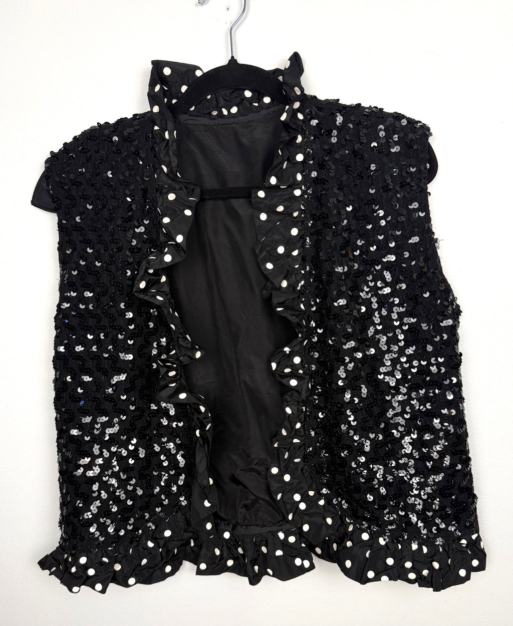 Black sequin vest with polka dot ruffle trim front view