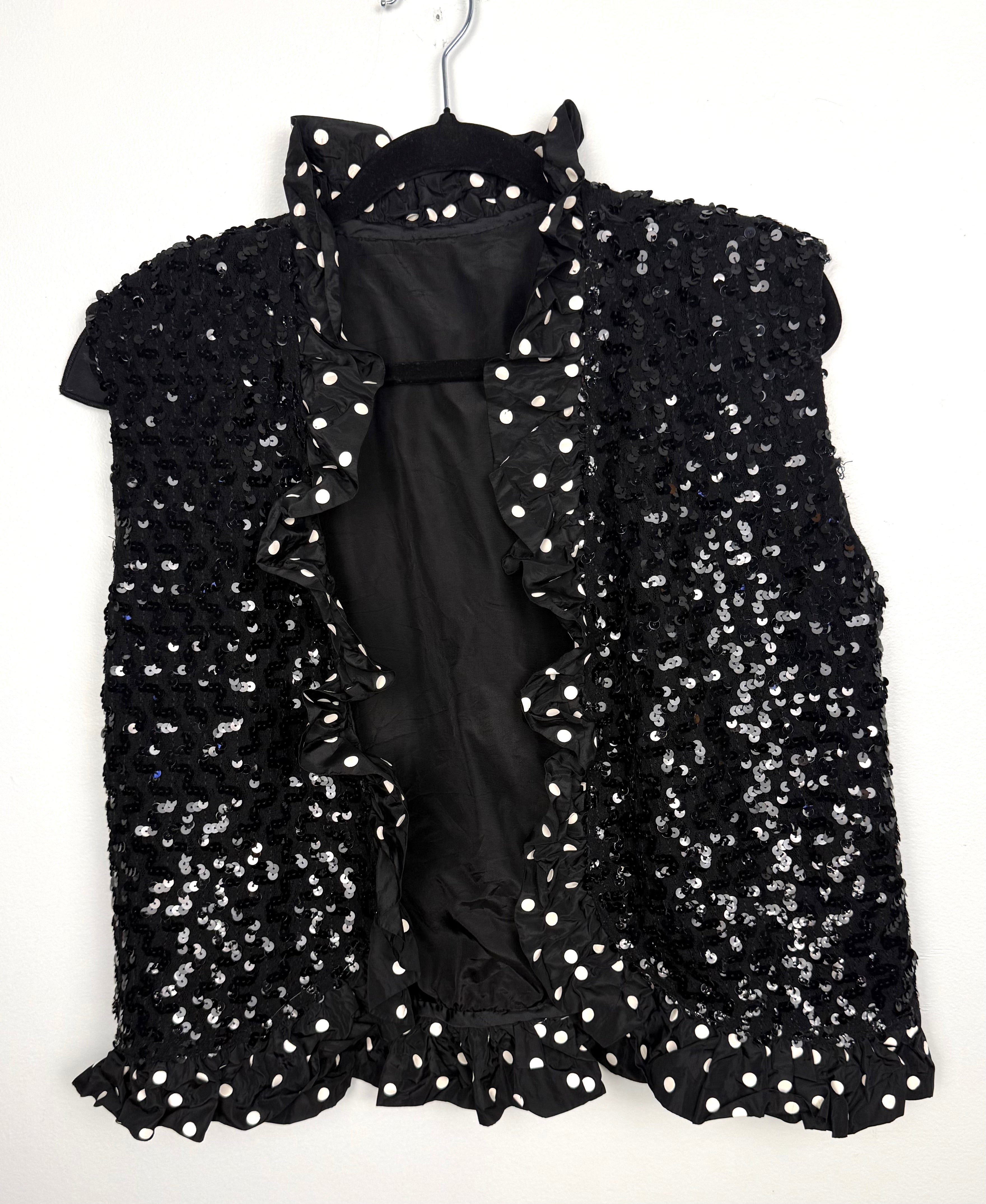 Black sequin vest with polka dot ruffle trim front view