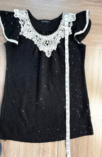Black sequinned top with crochet lace collar measuring 28 inches from shoulder to hem