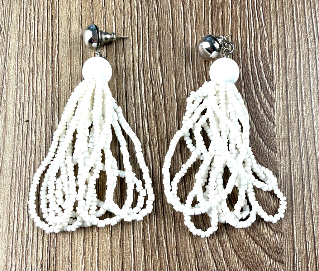 boho white Seed Bead Tassel Earrings  on table 