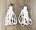 boho white Seed Bead Tassel Earrings  on table 
