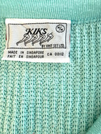 Brand label showing KIKS by Knit Set Ltd made in Singapore
