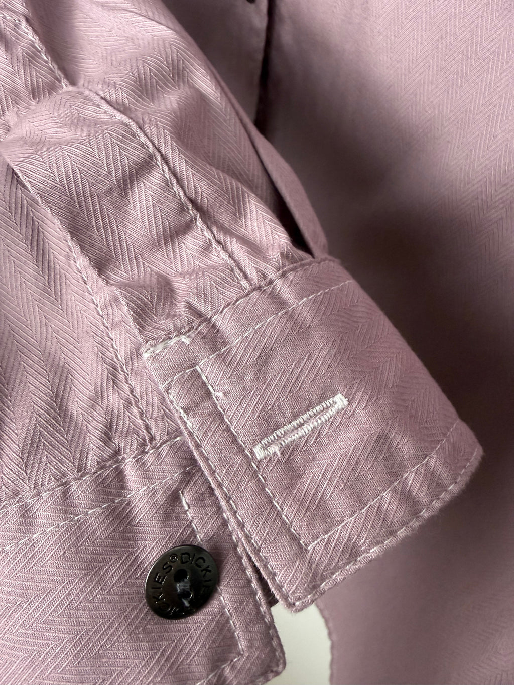Button cuff detail on Dickies mauve utility shirt, durable cotton workwear style.