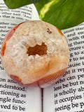close up of carnelian sphere with icy looking druzy 