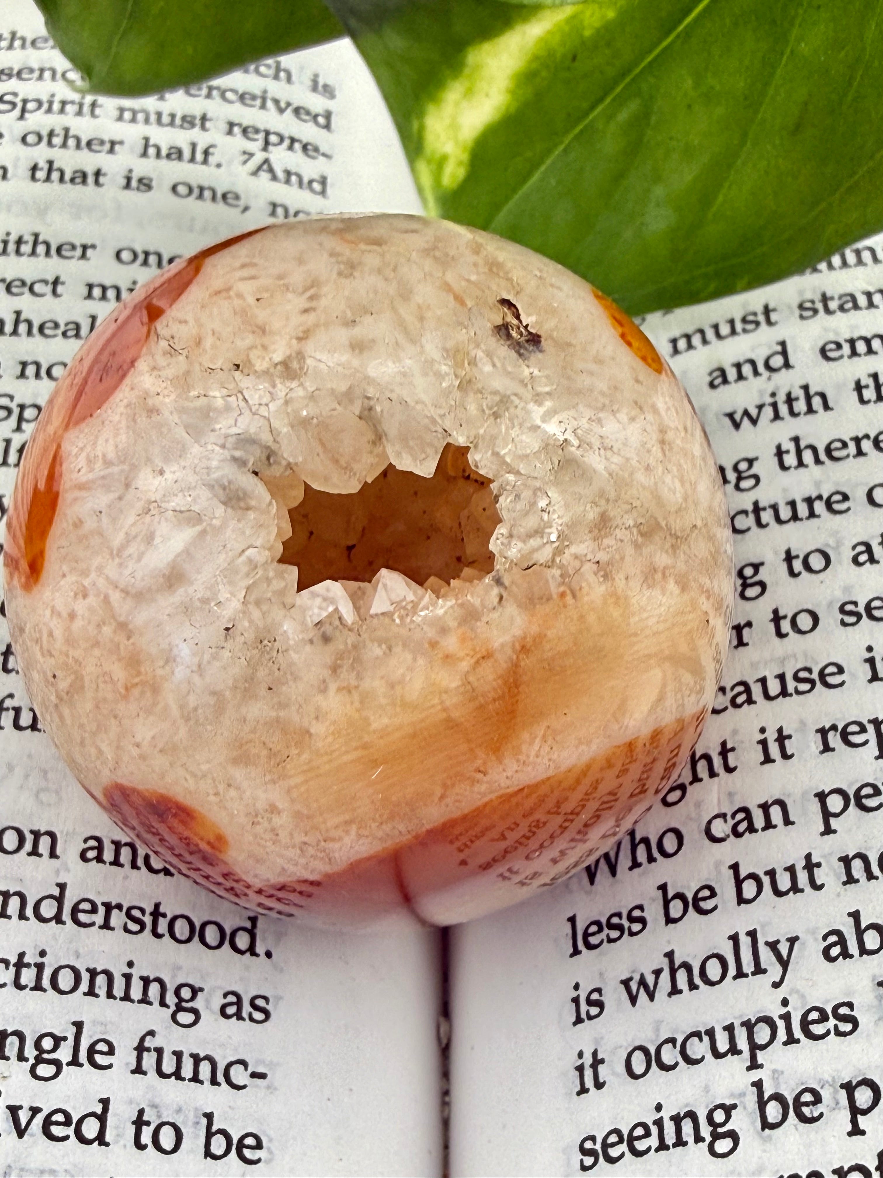 close up of carnelian sphere with icy looking druzy 