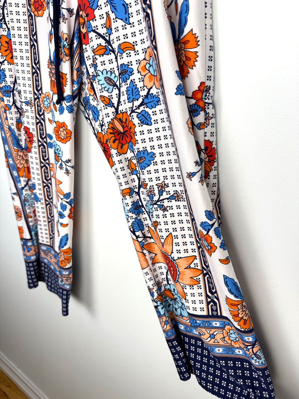 Casual boho patterned wide leg pants in orange and blue on hanger