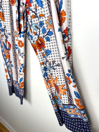 Casual boho patterned wide leg pants in orange and blue on hanger