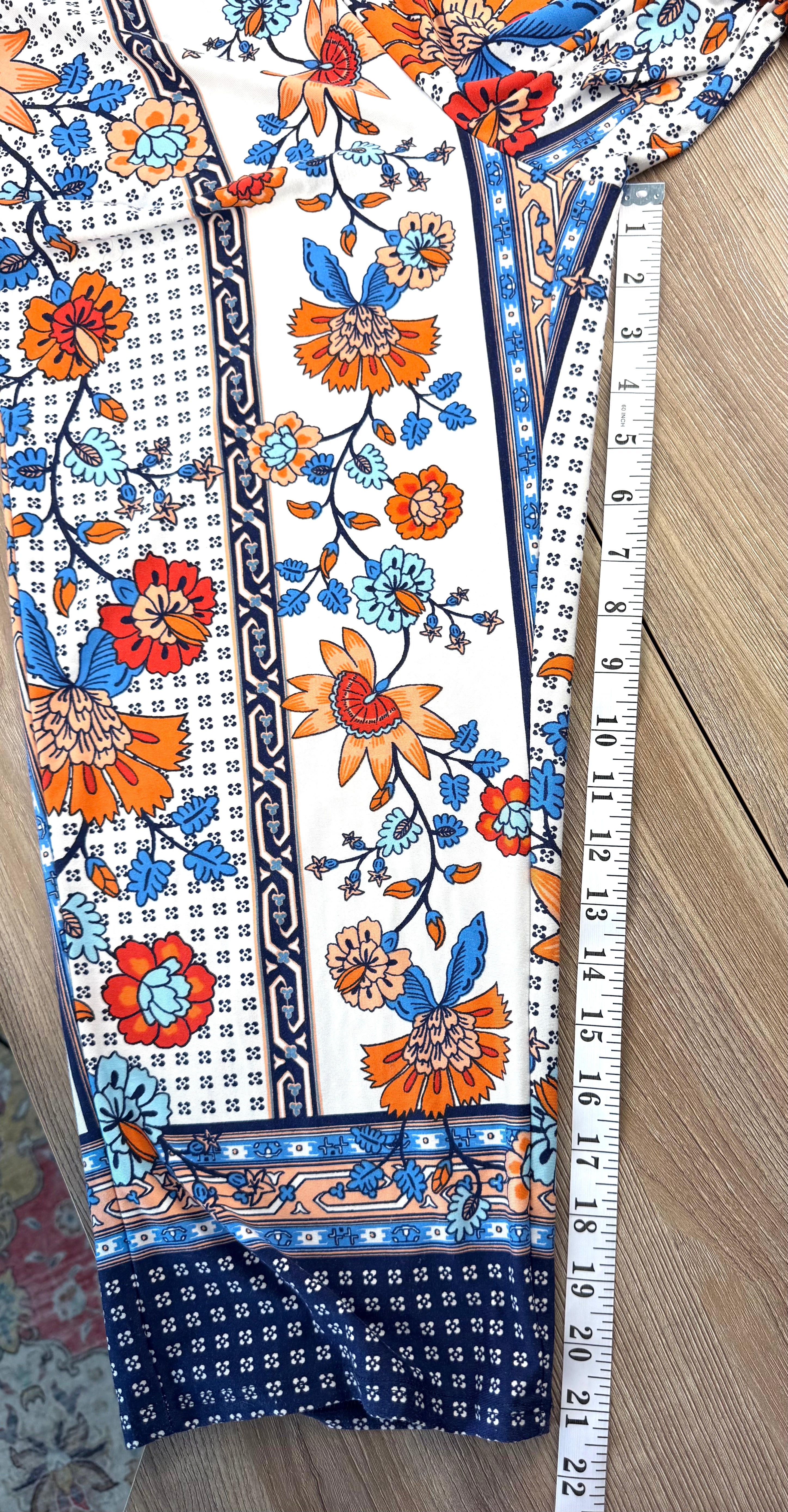 Casual boho patterned wide leg pants in orange and blue measuring 21" inseam 