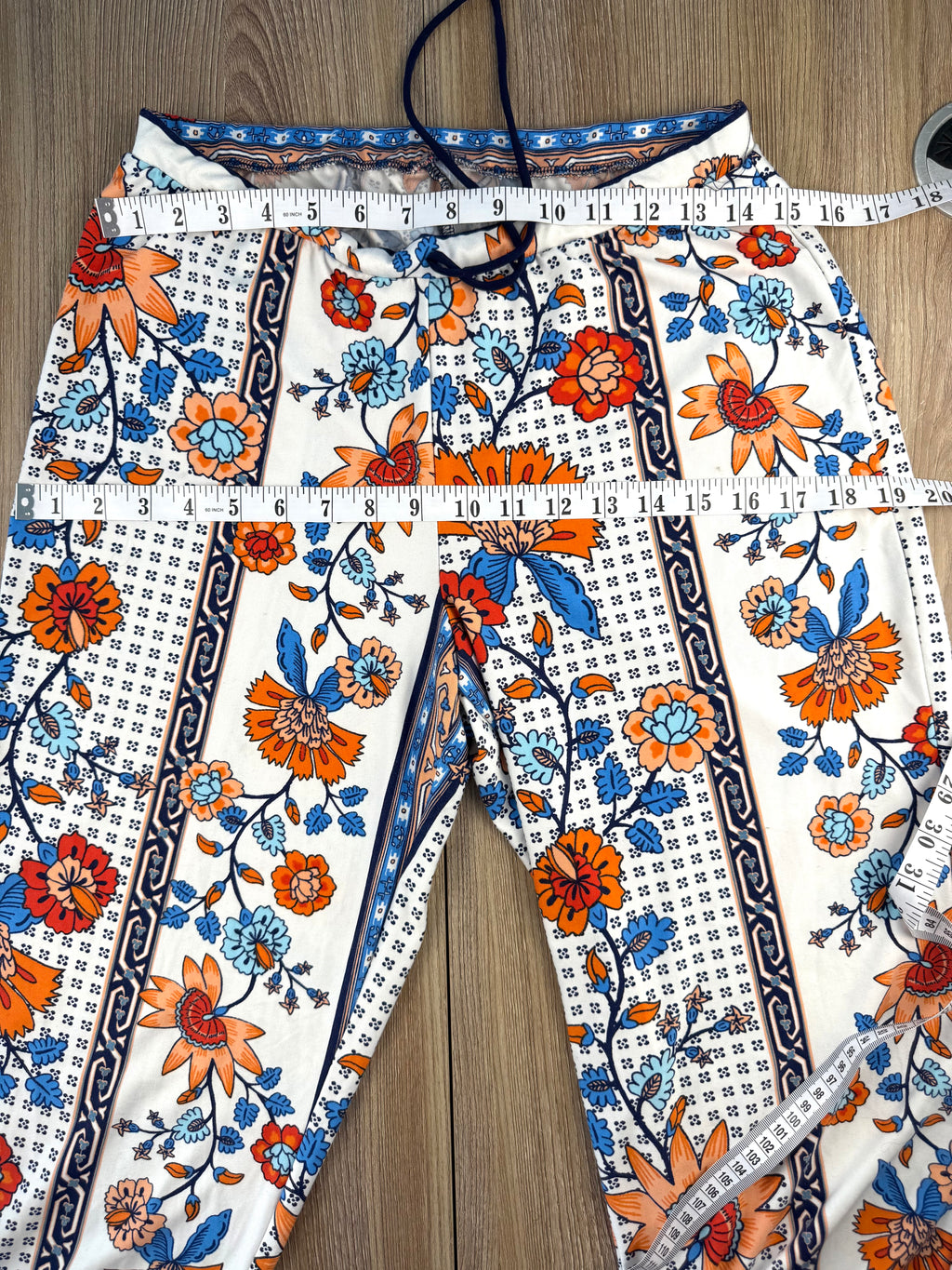 Casual boho patterned wide leg pants in orange and blue measuring 30" waist and 38" hips 