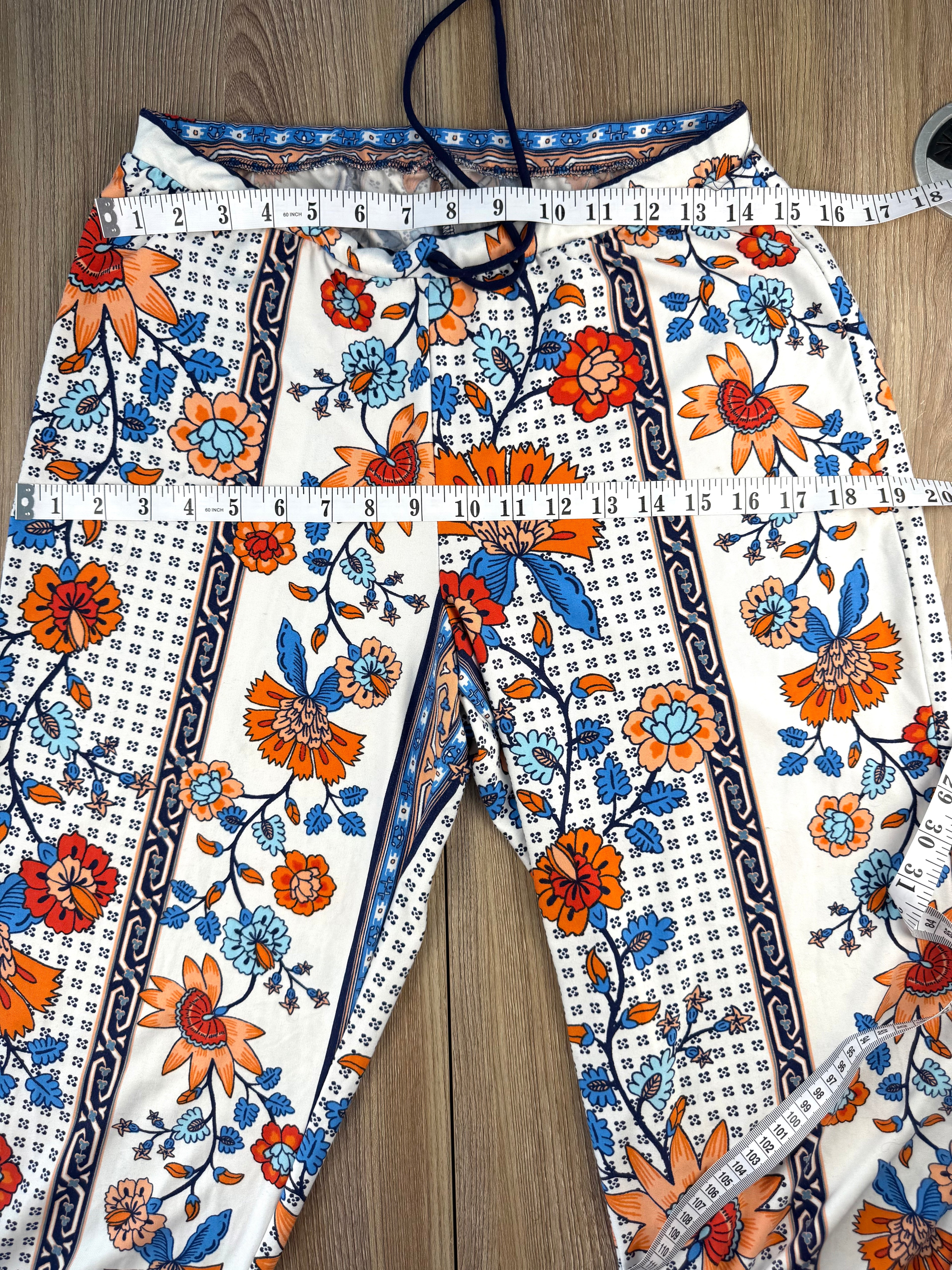 Casual boho patterned wide leg pants in orange and blue measuring 30" waist and 38" hips 