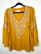 Chelsea & Theodore Embroidered Boho Blouse in mustard yellow on hanger 