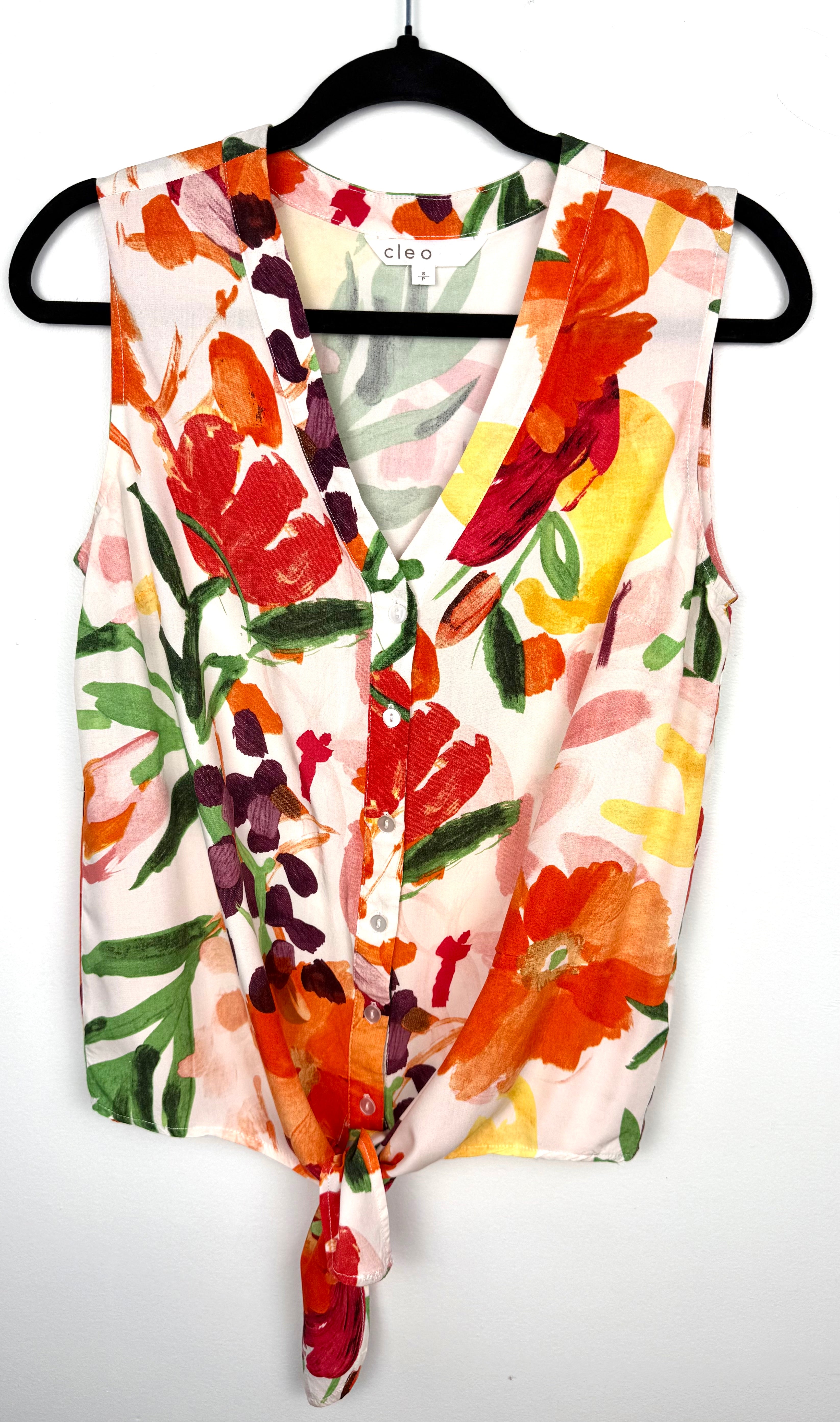 Cleo tie-front V-neck floral blouse in bold painterly orange red and green botanical print on hanger