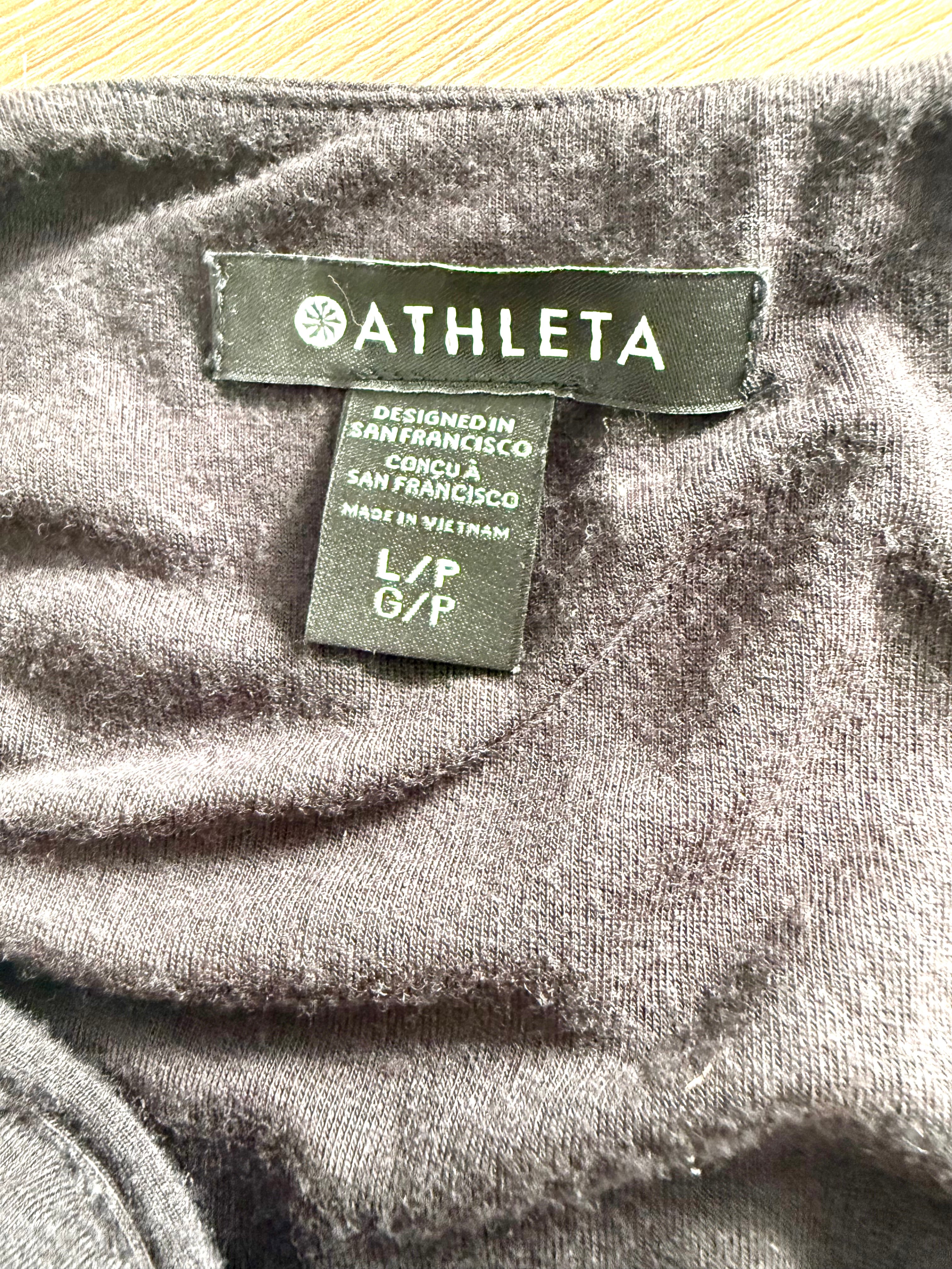 Close-up of Athleta brand label showing size L/P G/P and Designed in San Francisco detail.