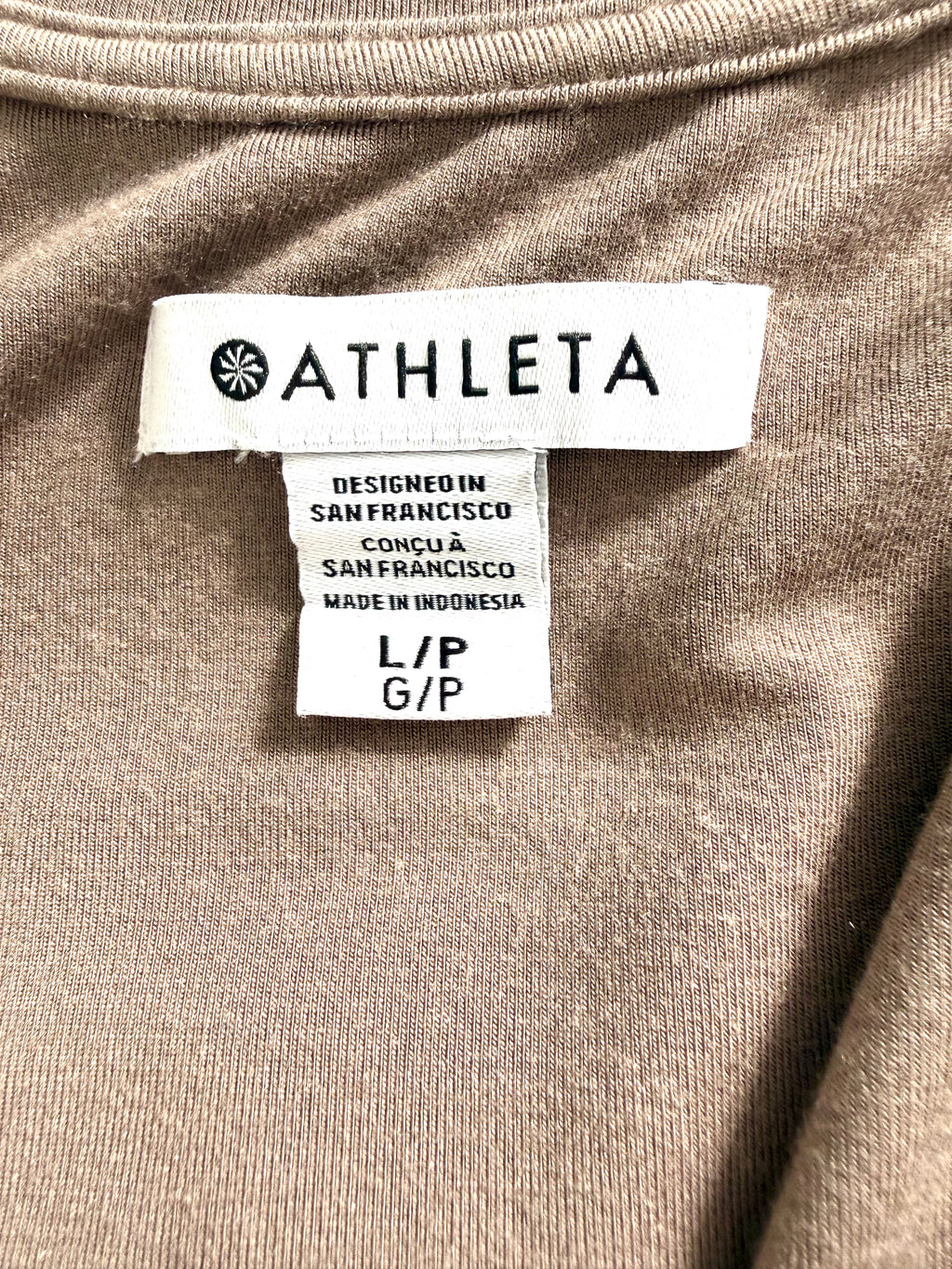 Close-up of Athleta brand label showing size Large (L/P G/P) and designed in San Francisco.