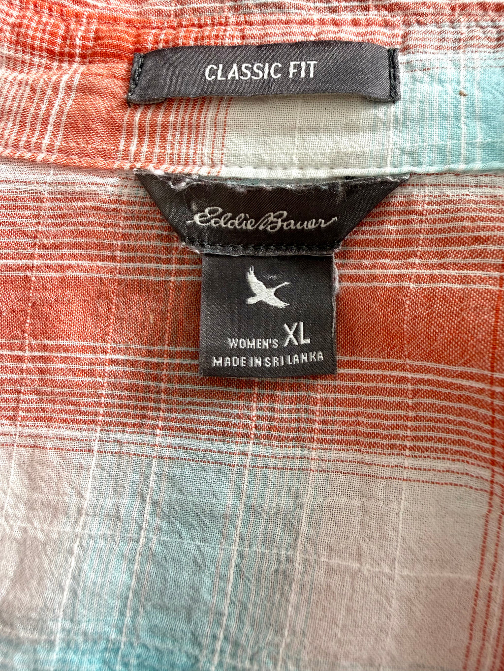 Close-up of Eddie Bauer label showing women’s XL classic fit.