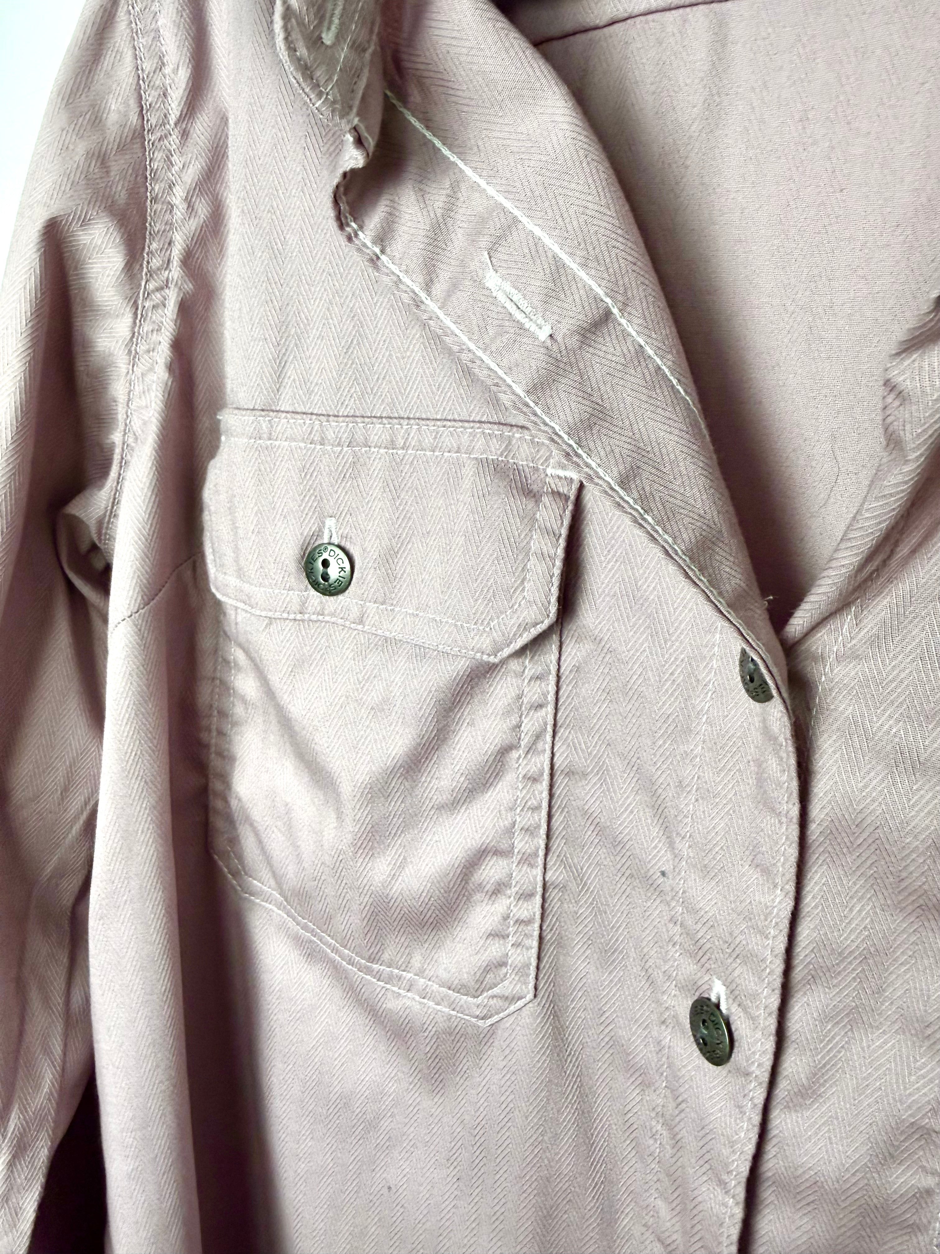 Close up of Dickies branded button and cargo flap chest pocket on dusty rose coloured herringbone work shirt.