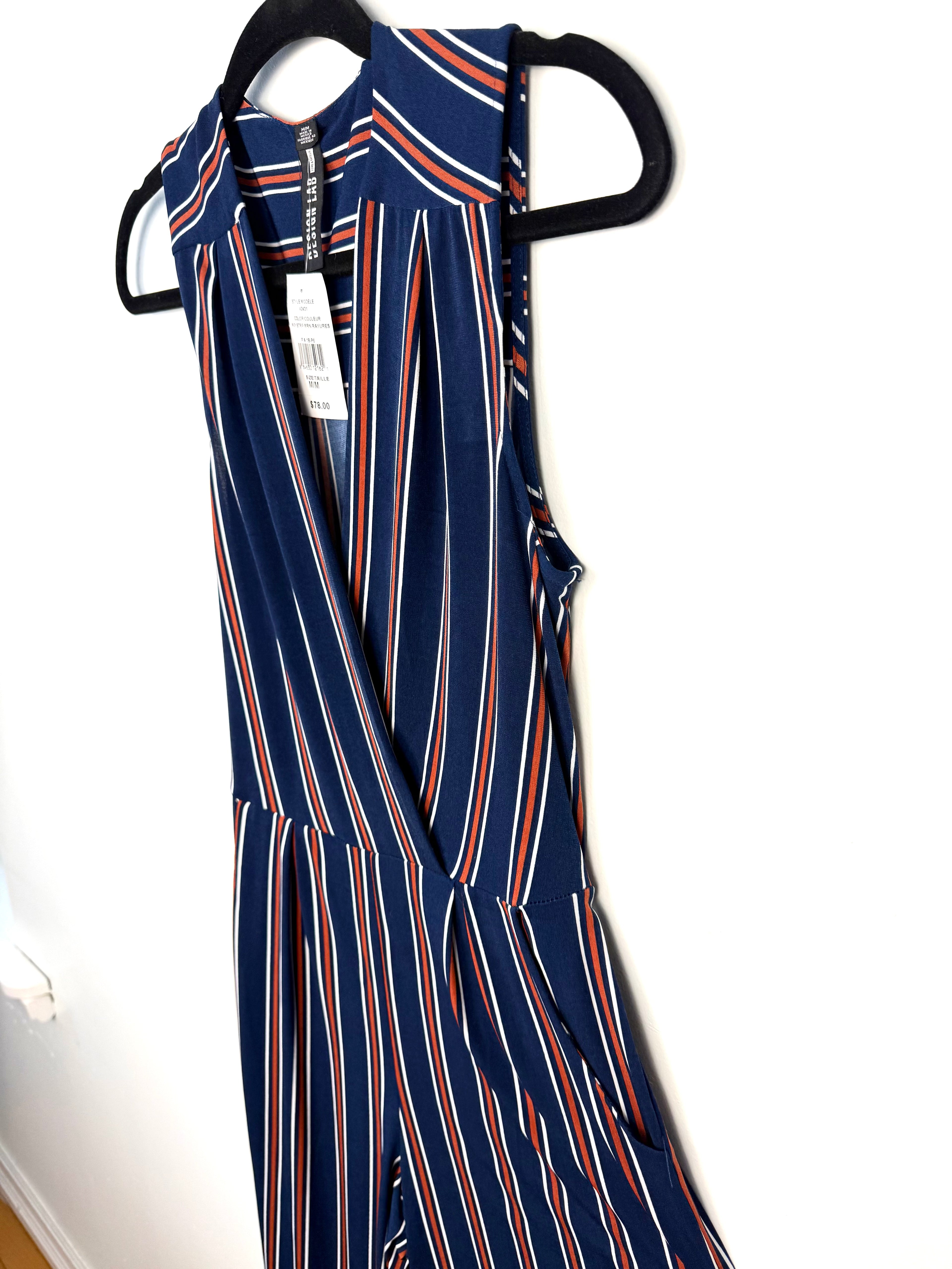 Close up of wrap front V neckline navy striped jumpsuit NWT  on hanger