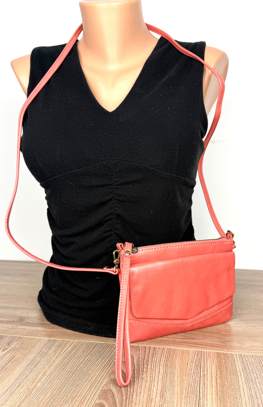 HOBO International Leather Crossbody Wristlet Bag in Coral on mannequin to show size 