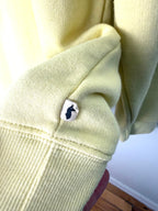 Cotopaxi logo on Do Good sweatshirt in yellow