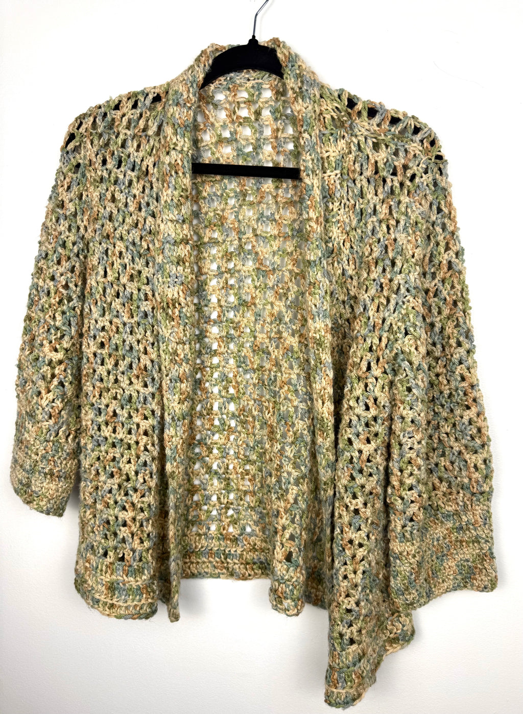 Cottagecore Handmade Crochet Cardigan in earth tones  on hanger