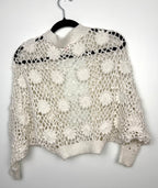 Cottagecore crochet look shrug  back view  on hanger