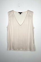 Cream Banana Republic sleeveless blouse featuring a V-neckline, gathered shoulder detail, relaxed silhouette, and fluid drape throughout the body. on white background