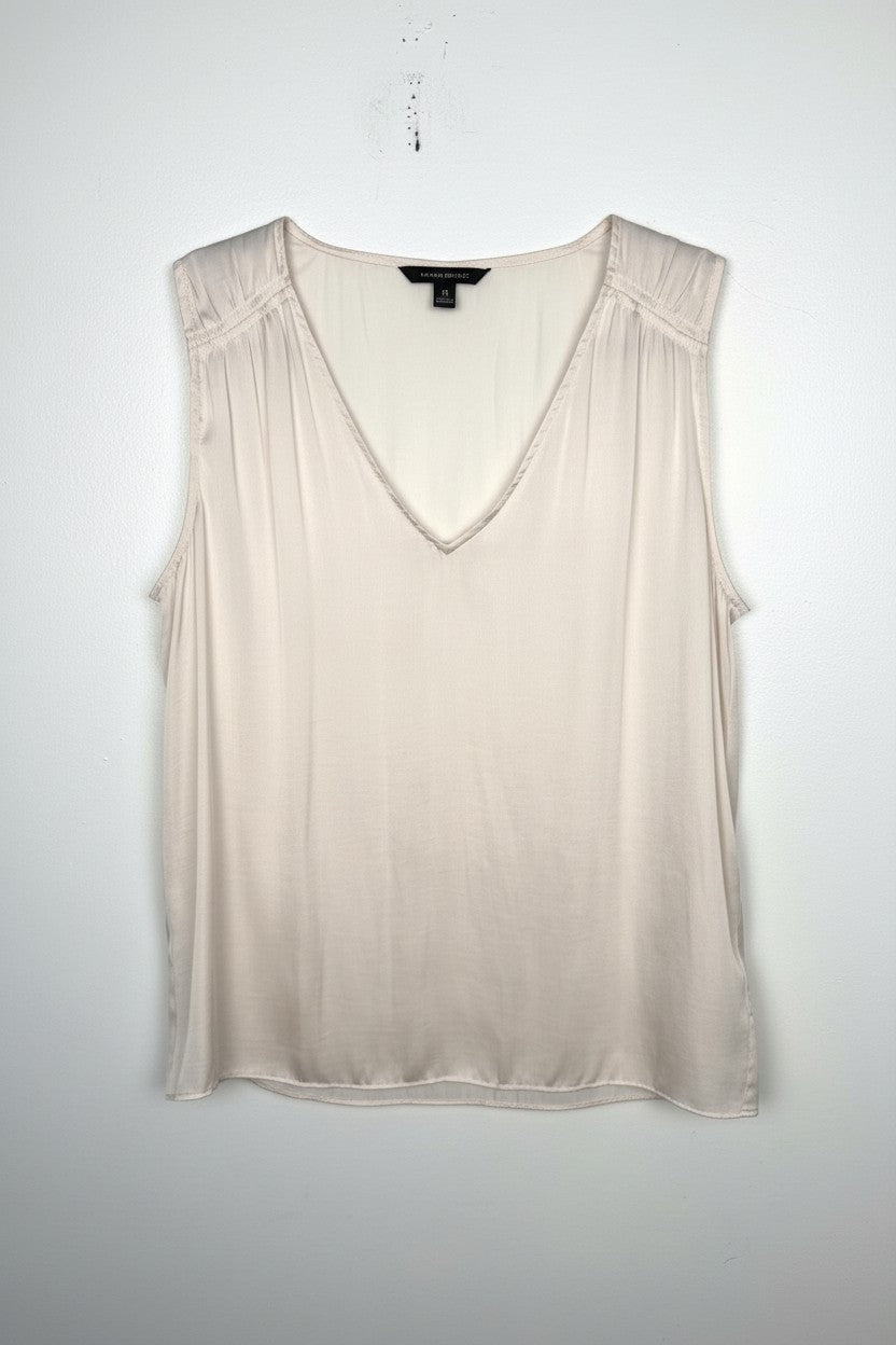 Cream Banana Republic sleeveless blouse featuring a V-neckline, gathered shoulder detail, relaxed silhouette, and fluid drape throughout the body. on white background